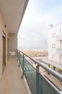 a balcony of a building with a view of the ocean at Perola Mar in Nazaré