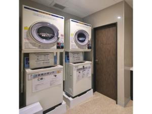 a laundry room with three washing machines and a door at Hotel Halrotto Fukuoka Hakata - Vacation STAY 18612v in Fukuoka +51 photos