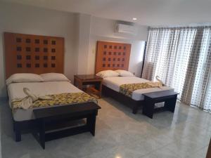 Postel nebo postele na pokoji v ubytování Hotel Ziami