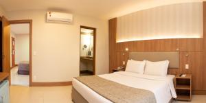 - une chambre avec un grand lit dans une chambre d'hôtel dans l'établissement Hotel Astoria Copacabana, à Rio de Janeiro