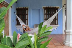 a woman lying in a hammock in a house at Bungalows Santa Cruz in Puerto Escondido +24 photos