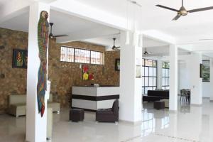 a living room with a ceiling fan and a couch at Hotel Cacique Guaicani in Melgar