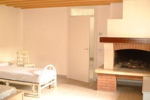 a bedroom with a bed and a fireplace at Casa Maculan in Villaverla