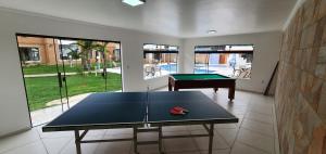 a ping pong table in a room with a pool table at Grand Ville Hotel in São Lourenço