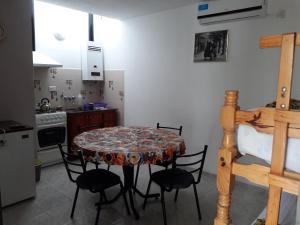 a kitchen with a table and chairs in a room at La Nona in Villa Cura Brochero