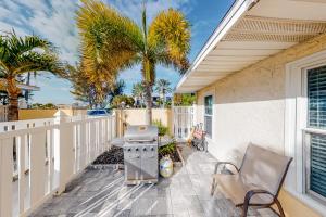 a patio with a grill and palm trees on a house at Sea Pirate 1 in Holmes Beach
