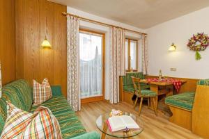 een woonkamer met een bank en een tafel bij Gästehaus Else in Reit im Winkl