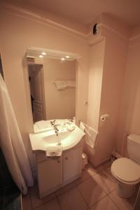 a bathroom with a sink and a toilet and a mirror at Résidence Côté Sud La Bouilladisse in La Bouilladisse