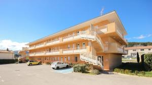 a building with a staircase in a parking lot at Résidence Côté Sud La Bouilladisse in La Bouilladisse