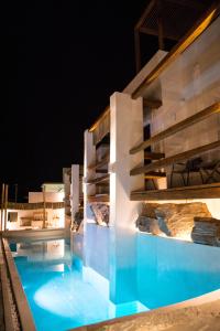 a view of a swimming pool at night at Sandaya Luxury Suites in Naousa