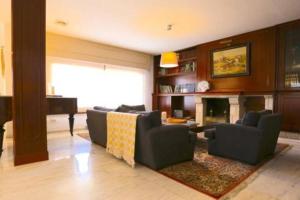 a living room with a couch and a piano at VILLA CERCA DE LA PLAYA,PISCINA PRIVADA,BBq in Málaga