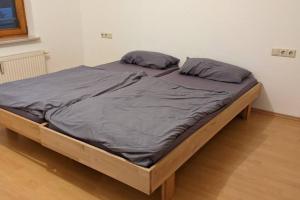 a bed with two pillows on it in a room at Helle Terrassenwohnung am Waldrand in Nürtingen