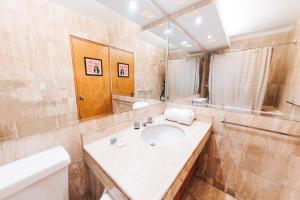 a bathroom with a sink and a mirror at qema Lima in Lima +25 photos