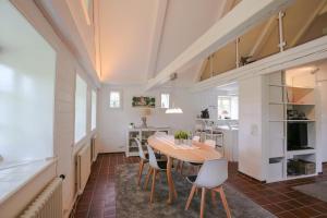 a kitchen and dining room with a table and chairs at Landhaus Risum in Risum-Lindholm