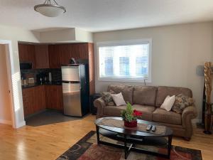 a living room with a couch and a table at Dragonfly Inn Loft Suite in Sherwood Park