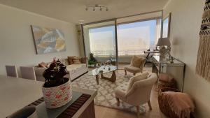 a living room with a large window with a view at Apartamento Diario Centro in Iquique
