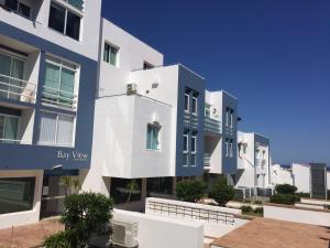 a large building with blue and white at Deluxe apartment in Albufeira old town, 200m walk to beach, pool parking in Albufeira