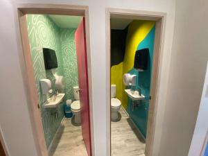a bathroom with two sinks and two toilets at Hello! Accommodation in Tauranga