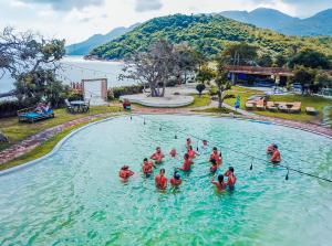 
people are swimming in a pool at Vietnam Backpacker Hostels - Ninhvana in Nha Trang
