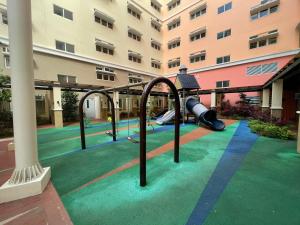 an empty playground in front of a building at Khentdrick's Place at Holland Park Southwoods in Biñan