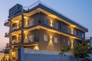 a large apartment building with lights on at Loft 24, Mansarovar in Jaipur