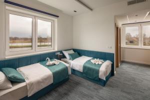 Posteľ alebo postele v izbe v ubytovaní Sziget Hotel