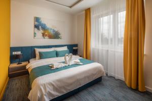 Posteľ alebo postele v izbe v ubytovaní Sziget Hotel