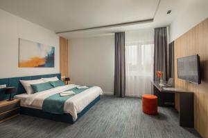 Posteľ alebo postele v izbe v ubytovaní Sziget Hotel