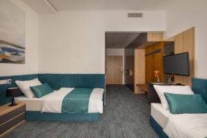 Posteľ alebo postele v izbe v ubytovaní Sziget Hotel