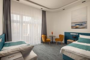 Posteľ alebo postele v izbe v ubytovaní Sziget Hotel