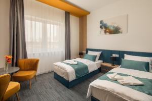 Posteľ alebo postele v izbe v ubytovaní Sziget Hotel