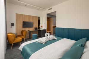 Posteľ alebo postele v izbe v ubytovaní Sziget Hotel