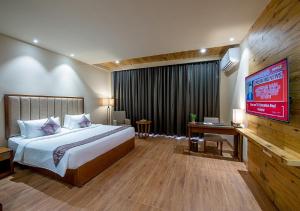 Postel nebo postele na pokoji v ubytování Hotel Cachar Club