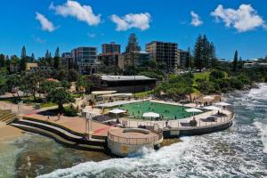 a resort on a river with a pool of water at Kings Edge in Caloundra