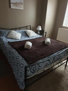a bedroom with a bed with towels on it at appartement malo les bains plage in Dunkerque