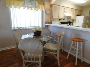 a kitchen with a table and chairs and a counter at Tilghman Shores D9 in Myrtle Beach