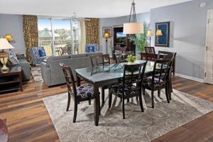 a dining room and living room with a table and chairs at Yacht Club Villas #1-204 condo in Myrtle Beach