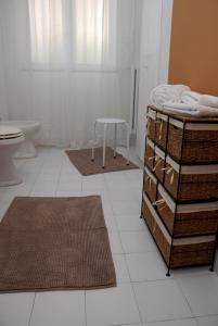 a bathroom with a toilet and a table and towels at A Caso in Avellino