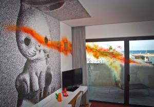 a living room with a painting of a bear on the wall at Pestana Cidadela Cascais - Pousada & Art District in Cascais