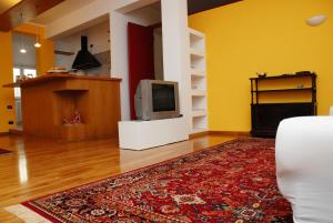 a living room with a television and a rug at A Caso in Avellino