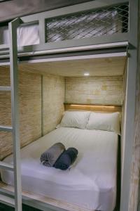 a bunk bed with two pillows on top of it at Dormitory at Semadi living in Sukawati