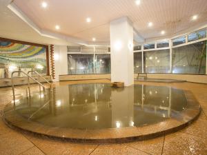 a large room with a pool of water in the middle of a floor at Ikaho Grand Hotel in Shibukawa +17 photos