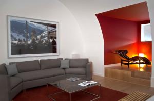 a living room with a couch and a table at Pestana Cidadela Cascais - Pousada & Art District in Cascais