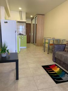 a kitchen and a living room with a white refrigerator at Сучасна квартира біля ТРЦ"Французький бульвар"15 лікарня! in Kharkiv