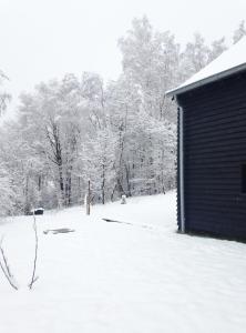 a snow covered yard next to a building at Chalet d'Orti in Sainte-Ode