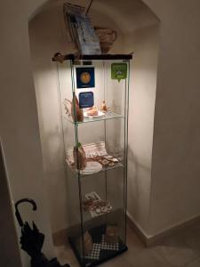 a glass shelf with items on it in a room at B&B del Corso Altamura in Altamura