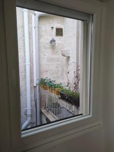 a window view of a balcony with plants at B&B del Corso Altamura in Altamura