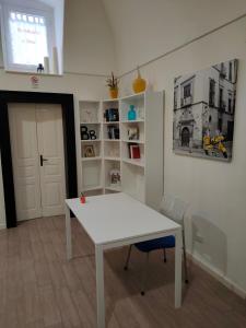 a white table and a chair in a room at B&B del Corso Altamura in Altamura
