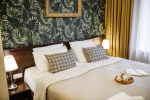 a hotel room with a bed with two pillows at Art Hotel Bohema, Klaipėda in Klaipėda