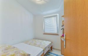 Postel nebo postele na pokoji v ubytování Apartmani Vugec, Povljana - Pag